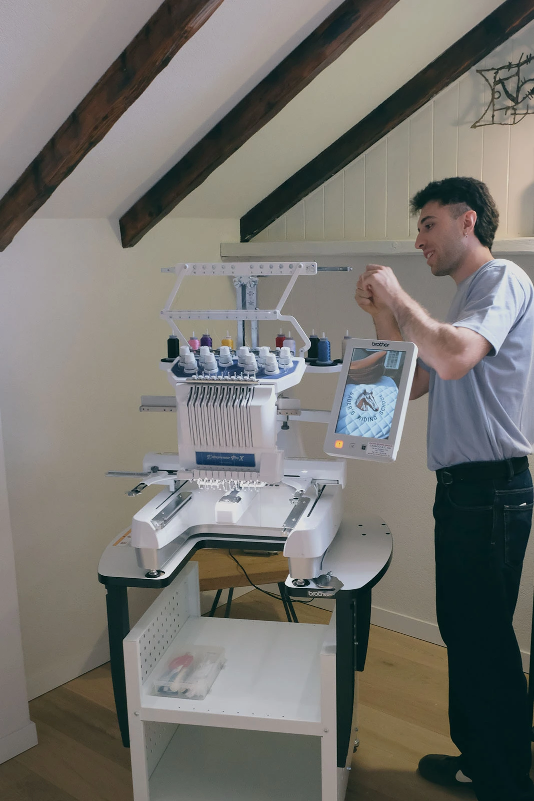 Alessio Solazzi mentre prepara la macchina ricamatrice Brother PR